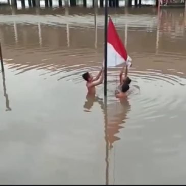 Murid SD di PALI Kibarkan Bendera Merah Putih di Tengah Banjir
