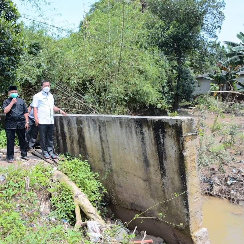 Wakil Bupati Karawang, H. Aep Syaepuloh SE meninjau lokasi jebolnya tanggul di Desa Wadas, Kecamatan Telukjambe Timur, dekat Perumahan Harmony Telukjambe, Jumat(12/03/2021).